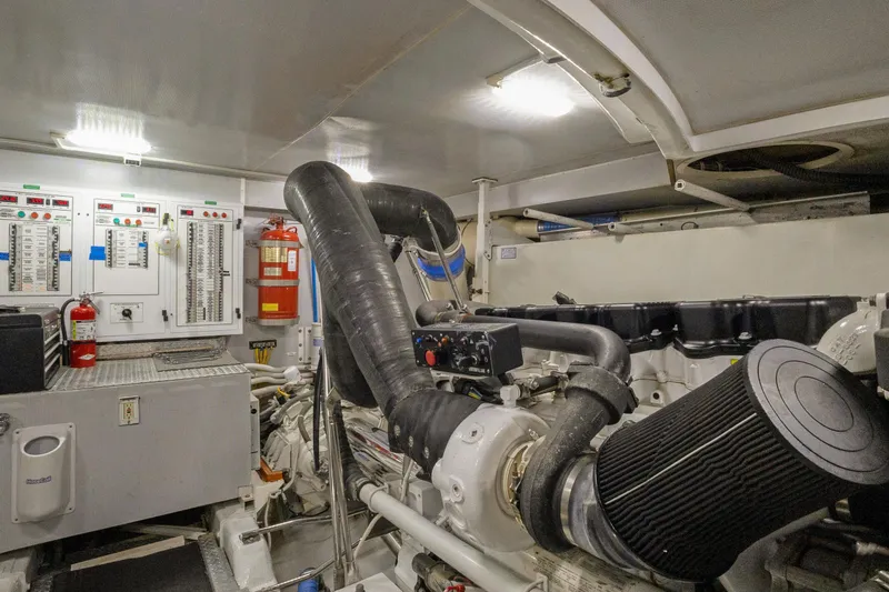 Slide: The Image of Engine room of 2008 Marquis 690 yacht with control panels and fire extinguishers. - 57