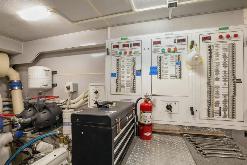 Slide: The Image of Electrical control room of 2008 Marquis 690 yacht with panels, tools, and safety equipment. - 59