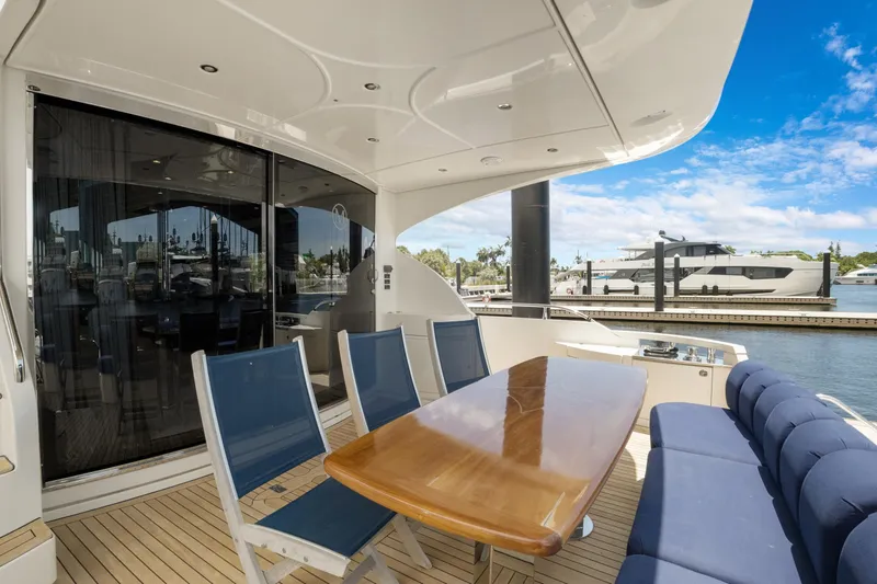Slide: The Image of Luxury yacht Marquis 690 (2008) with elegant outdoor seating and scenic marina view. - 6