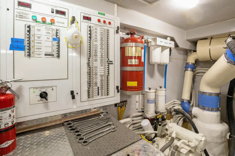 Slide: The Image of Engine room of a 2008 Marquis 690 yacht with control panels and tools. - 60