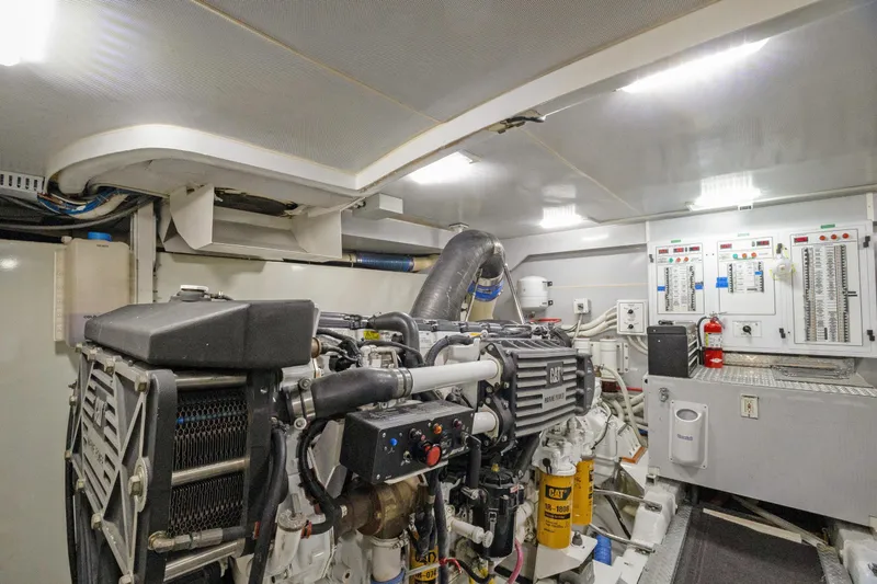 Slide: The Image of Engine room of a 2008 Marquis 690 yacht, featuring a CAT marine engine. - 62