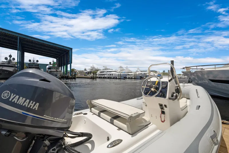 Slide: The Image of Boat docked at marina with Yamaha engine, clear blue sky, Marquis 690, 2008 model. - 63