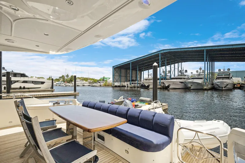 Slide: The Image of Luxury yacht Marquis 690, 2008 model, docked at marina with spacious outdoor seating. - 7