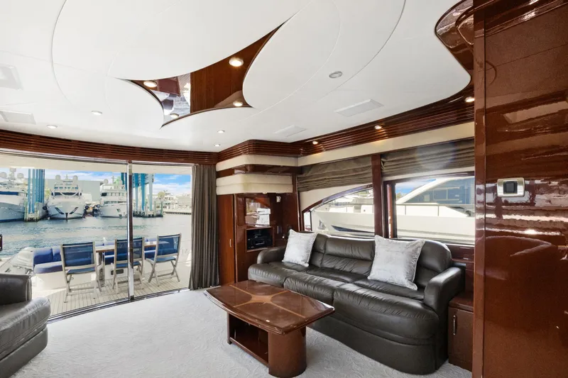 Slide: The Image of Luxurious interior of 2008 Marquis 690 yacht with leather seating and marina view. - 8