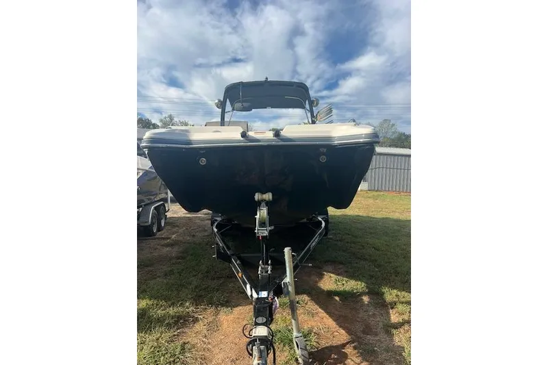 Slide: The Image of 2016 Starcraft Crossover 231 SCX IO SURF boat on trailer, under cloudy sky. - 4