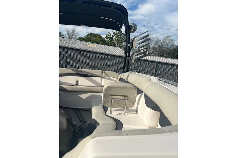 Slide: The Image of 2016 Starcraft Crossover 231 SCX IO SURF boat interior with beige seating and wakeboard rack. - 6