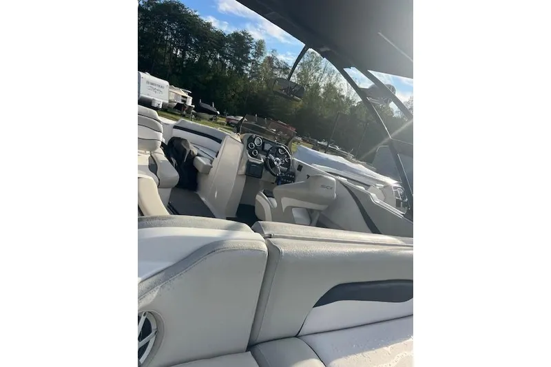 Slide: The Image of 2016 Starcraft Crossover 231 SCX IO SURF boat interior with steering wheel and seating. - 8