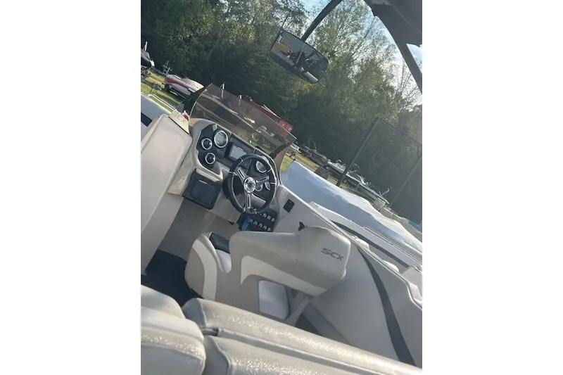 Slide: The Image of 2016 Starcraft Crossover 231 SCX IO SURF boat interior with steering wheel and dashboard. - 9