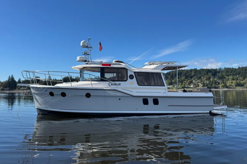 The Image of 2024 Ranger Tugs R-29 S boat docked in marina under clear blue sky. - 0