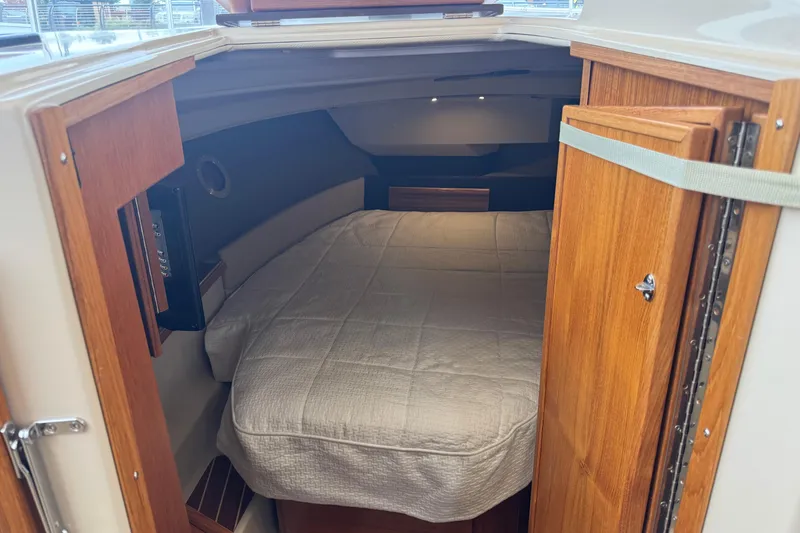 Slide: The Image of 2024 Ranger Tugs R-29 S helm with dual navigation screens and wooden steering wheel. - 11