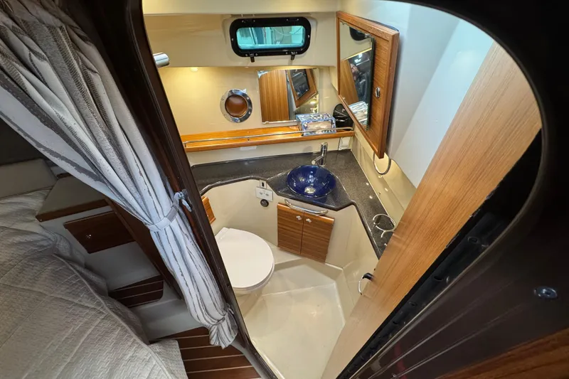 Slide: The Image of 2024 Ranger Tugs R-29 S interior cabin with wood finish and TV. - 13