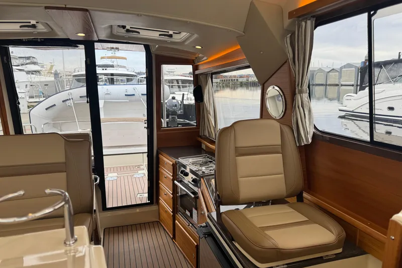 Slide: The Image of 2024 Ranger Tugs R-29 S bathroom with modern fixtures and wood accents. - 14