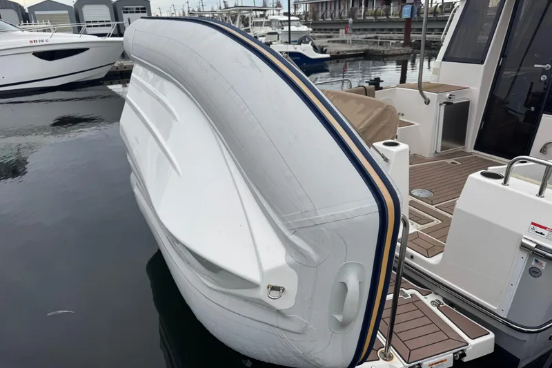 Slide: The Image of Yamaha outboard motor on 2024 Ranger Tugs R-29 S, docked by water. - 21