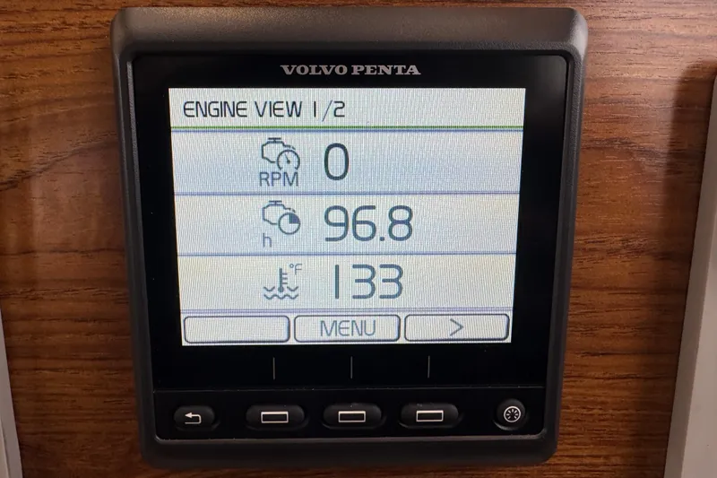 Slide: The Image of 2024 Ranger Tugs R-29 S helm with navigation screens and wooden steering wheel. - 9