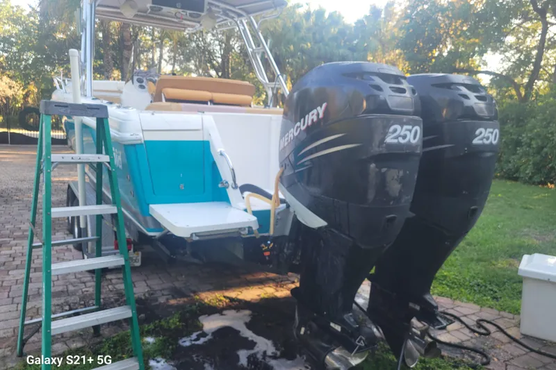 Slide: The Image of 2005 Intrepid 323 Cuddy boat with twin Mercury 250 engines on a sunny day. - 13