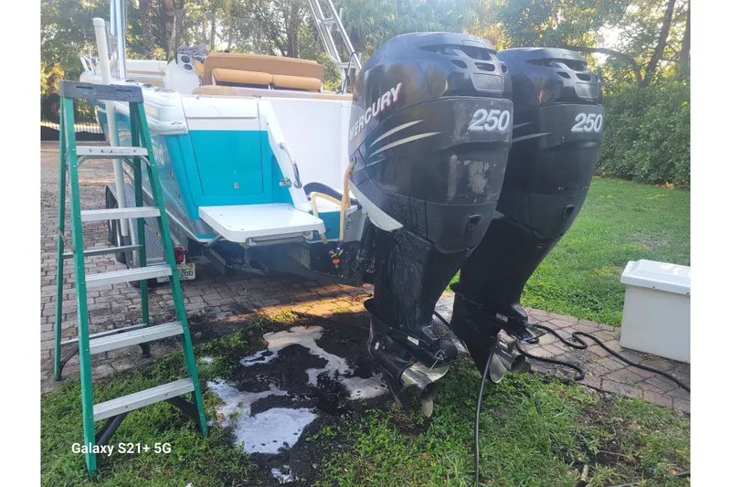 Slide: The Image of 2005 Intrepid 323 Cuddy boat with twin Mercury 250 engines on a trailer. - 14