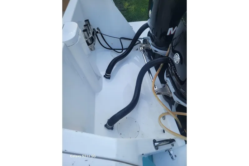 Slide: The Image of 2005 Intrepid 323 Cuddy boat engine compartment with cables and hoses. - 15