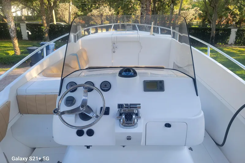 Slide: The Image of 2005 Intrepid 323 Cuddy boat cockpit with steering wheel and navigation equipment. - 16
