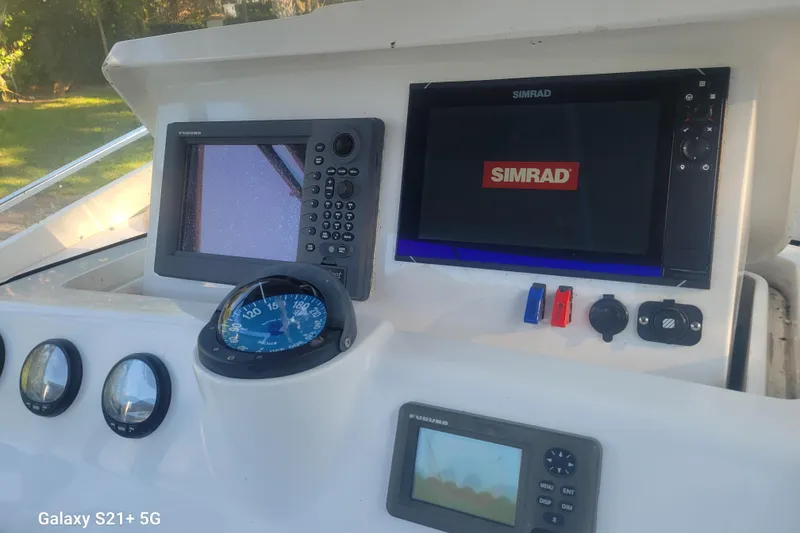 Slide: The Image of Dashboard of a 2005 Intrepid 323 Cuddy boat with navigation equipment. - 18