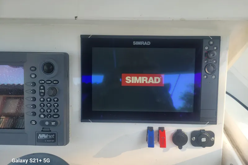Slide: The Image of Control panel of a 2005 Intrepid 323 Cuddy with Simrad and NAVnet displays. - 19