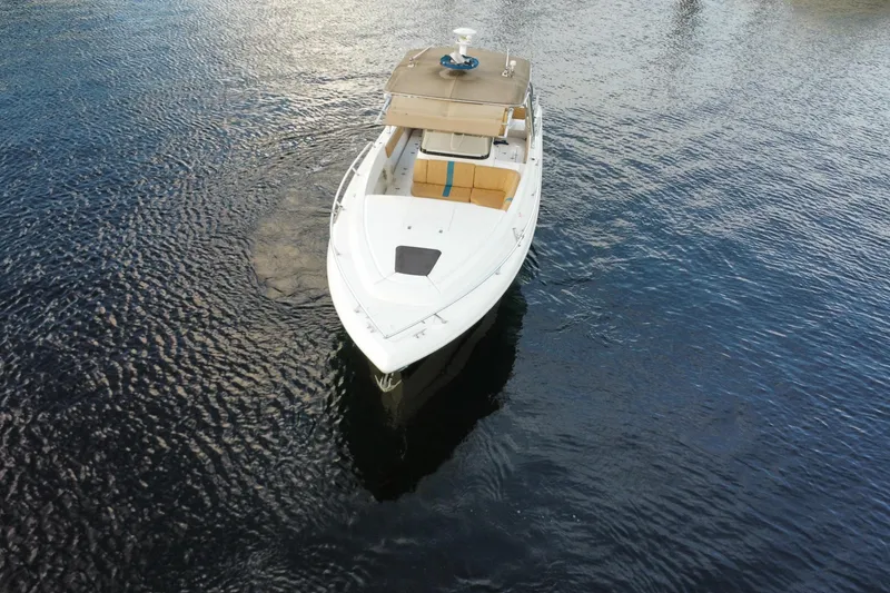 Slide: The Image of 2005 Intrepid 323 Cuddy boat on calm water, aerial view. - 2