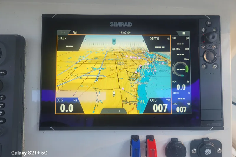 Slide: The Image of Simrad navigation display on 2005 Intrepid 323 Cuddy, showing nautical chart and vessel data. - 20