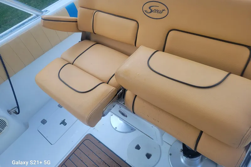 Slide: The Image of Tan leather seating on a 2005 Intrepid 323 Cuddy boat, featuring Scout branding. - 24
