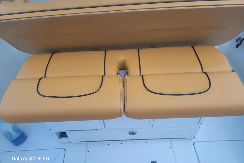 Slide: The Image of 2005 Intrepid 323 Cuddy boat seat with tan upholstery and black trim. - 25