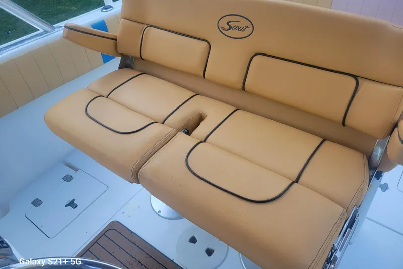 Slide: The Image of Tan leather seating on a 2005 Intrepid 323 Cuddy boat, featuring black trim accents. - 26