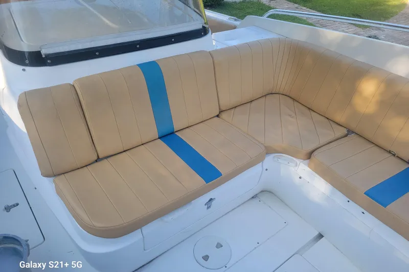 Slide: The Image of Beige and blue seating on 2005 Intrepid 323 Cuddy boat deck. - 39