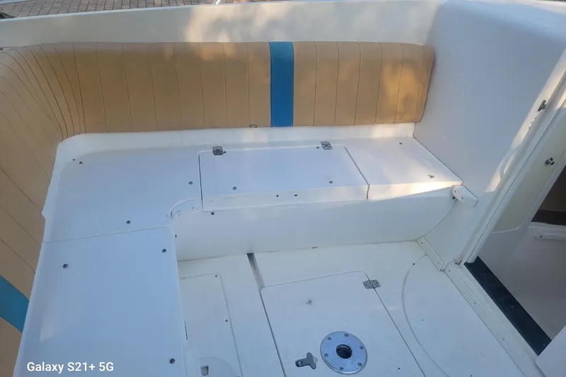 Slide: The Image of 2005 Intrepid 323 Cuddy boat interior with tan and blue seating. - 42