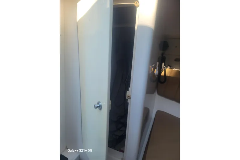 Slide: The Image of Interior view of a 2005 Intrepid 323 Cuddy cabin with open door. - 49