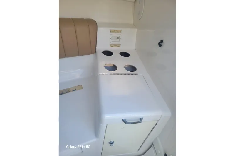 Slide: The Image of Interior of 2005 Intrepid 323 Cuddy boat with seating and storage. - 54