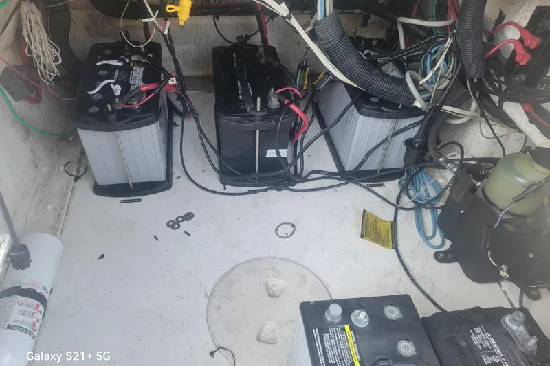 Slide: The Image of 2005 Intrepid 323 Cuddy boat battery compartment with wiring and components. - 61