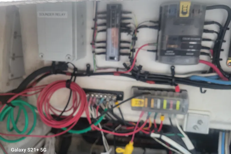 Slide: The Image of Electrical wiring and components inside a 2005 Intrepid 323 Cuddy boat. - 62