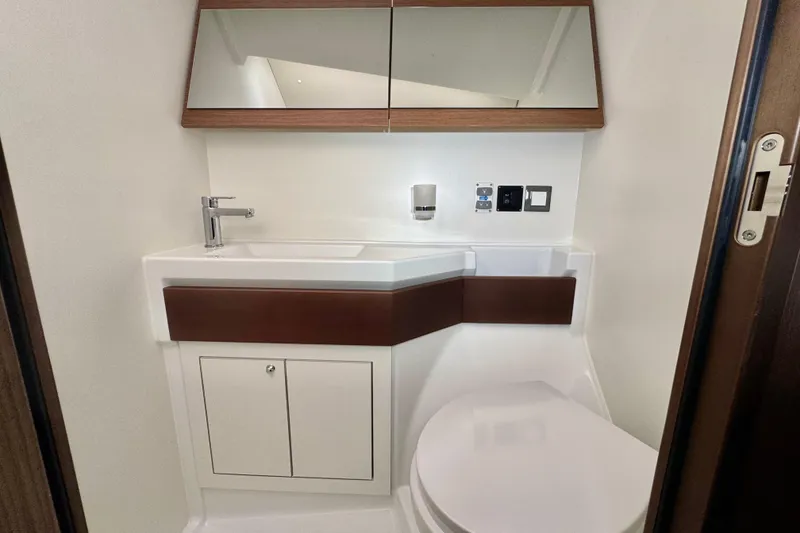 Slide: The Image of Modern bathroom in 2022 Beneteau Oceanis 46.1 yacht, featuring sleek sink and toilet design. - 11