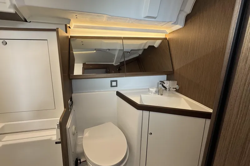 Slide: The Image of Modern bathroom interior of 2022 Beneteau Oceanis 46.1 yacht, featuring sleek design and wood accents. - 14