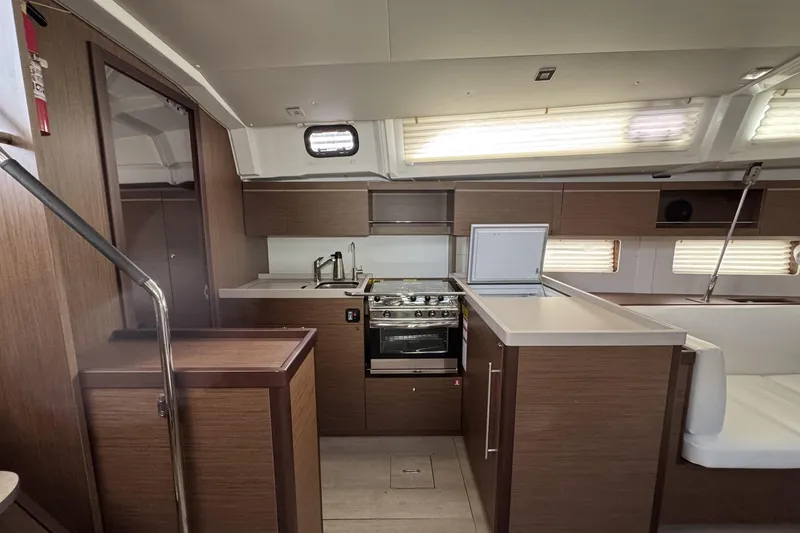 Slide: The Image of Modern kitchen interior of 2022 Beneteau Oceanis 46.1 yacht with wood finish. - 16
