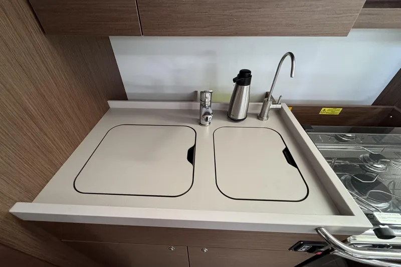 Slide: The Image of Modern kitchen sink area on 2022 Beneteau Oceanis 46.1 yacht, featuring sleek design and fixtures. - 17