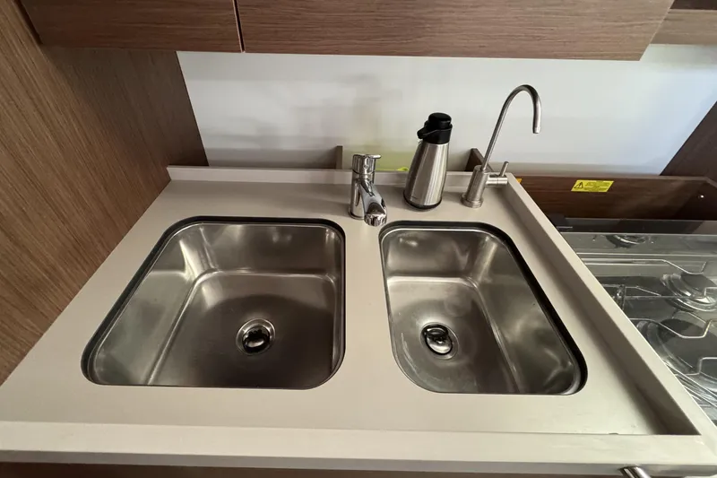 Slide: The Image of Modern kitchen sink with dual basins on Beneteau Oceanis 46.1 yacht, 2022 model. - 19
