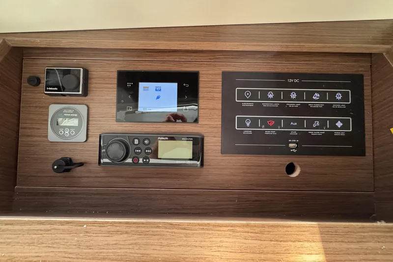 Slide: The Image of Control panel of a 2022 Beneteau Oceanis 46.1 yacht with various electronic displays. - 28