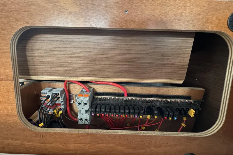 Slide: The Image of Electrical panel inside a 2022 Beneteau Oceanis 46.1 yacht, featuring wiring and circuit components. - 30