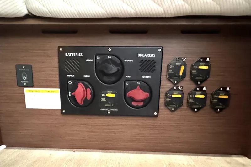 Slide: The Image of Electrical panel of a 2022 Beneteau Oceanis 46.1 yacht, featuring battery and breaker controls. - 31