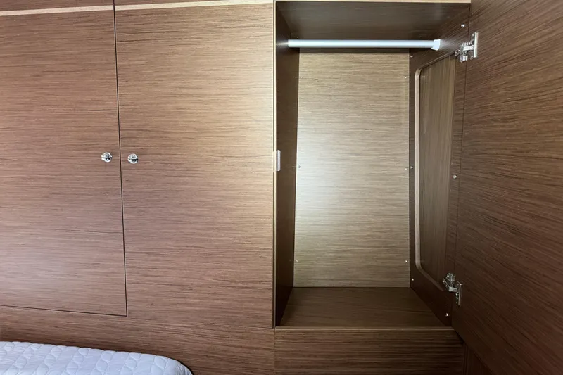 Slide: The Image of Interior wooden closet on 2022 Beneteau Oceanis 46.1 yacht, featuring open storage space. - 34