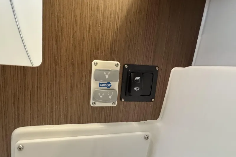 Slide: The Image of Control panel on 2022 Beneteau Oceanis 46.1 yacht, featuring Jabsco switches. - 35