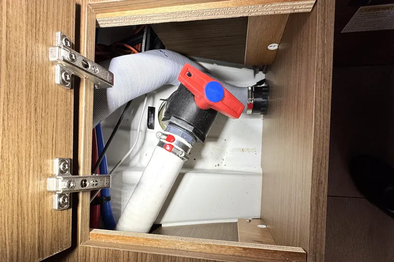 Slide: The Image of Interior plumbing of 2022 Beneteau Oceanis 46.1 yacht, featuring a red valve. - 39
