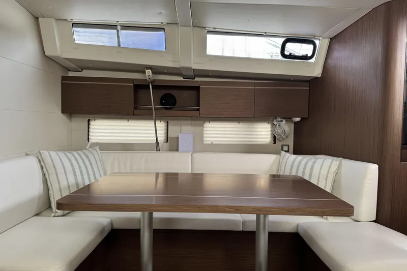 Slide: The Image of Interior of 2022 Beneteau Oceanis 46.1 yacht with modern dining area and wooden finishes. - 4