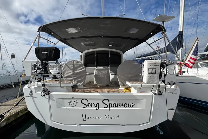 Slide: The Image of Beneteau Oceanis 46.1 sailboat, 2022 model, docked with covered seating and equipment. - 42