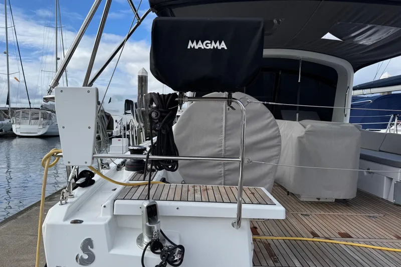 Slide: The Image of 2022 Beneteau Oceanis 46.1 yacht docked, featuring a covered Magma grill on deck. - 47