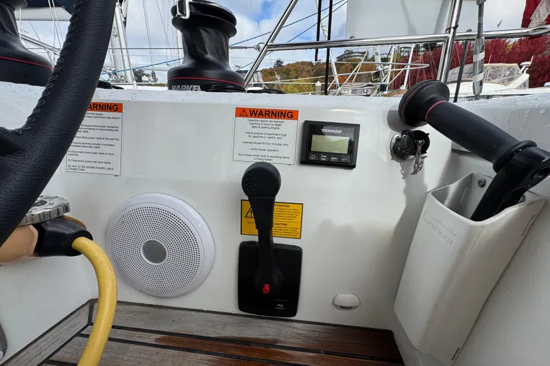 Slide: The Image of Cockpit controls of 2022 Beneteau Oceanis 46.1 sailboat, featuring steering wheel and navigation instruments. - 51